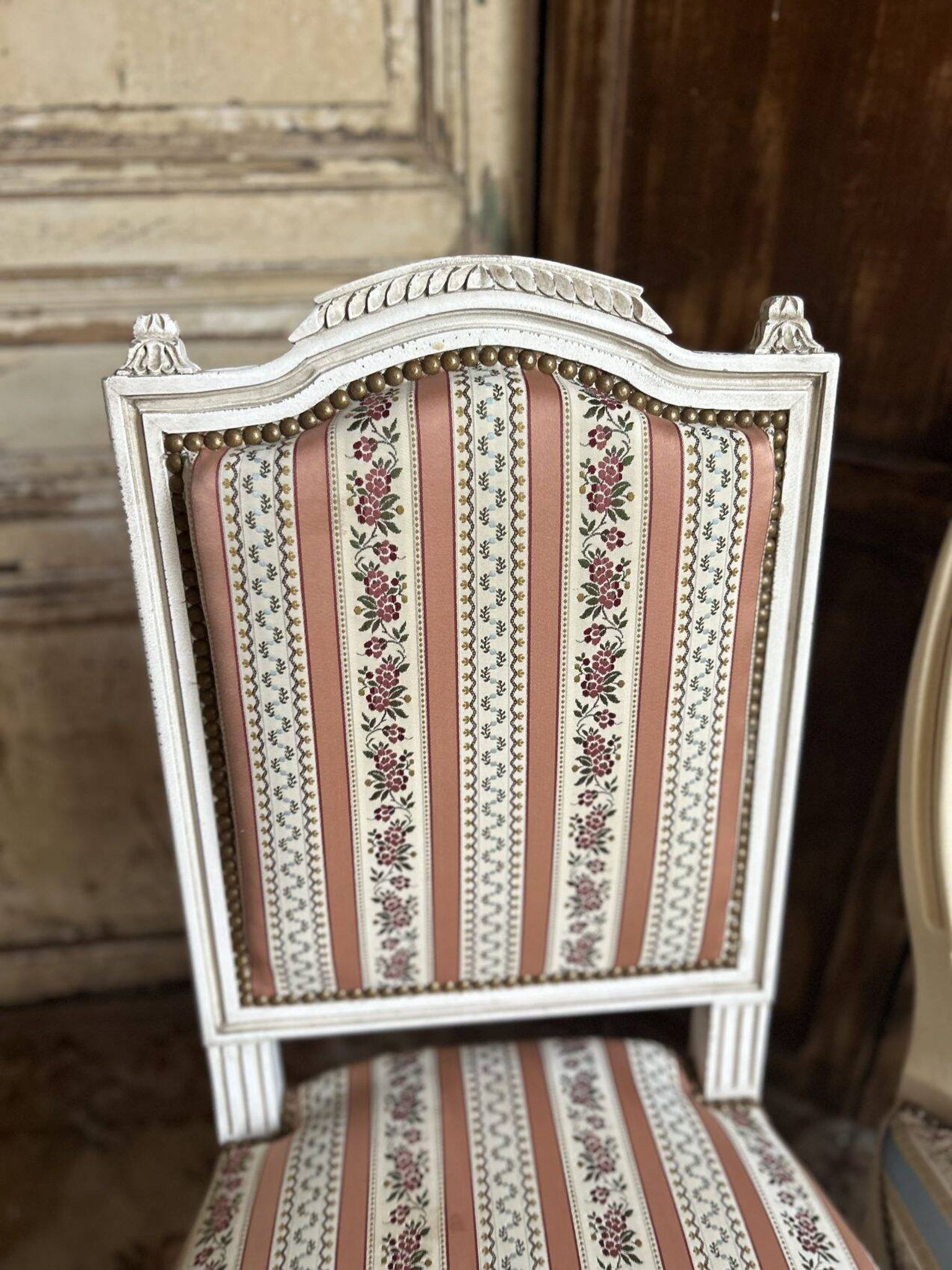 Pair of Louis XVI style chairs in painted wood and satin, classic elegance.