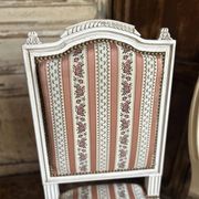 Pair of Louis XVI style chairs in painted wood and satin, classic elegance.