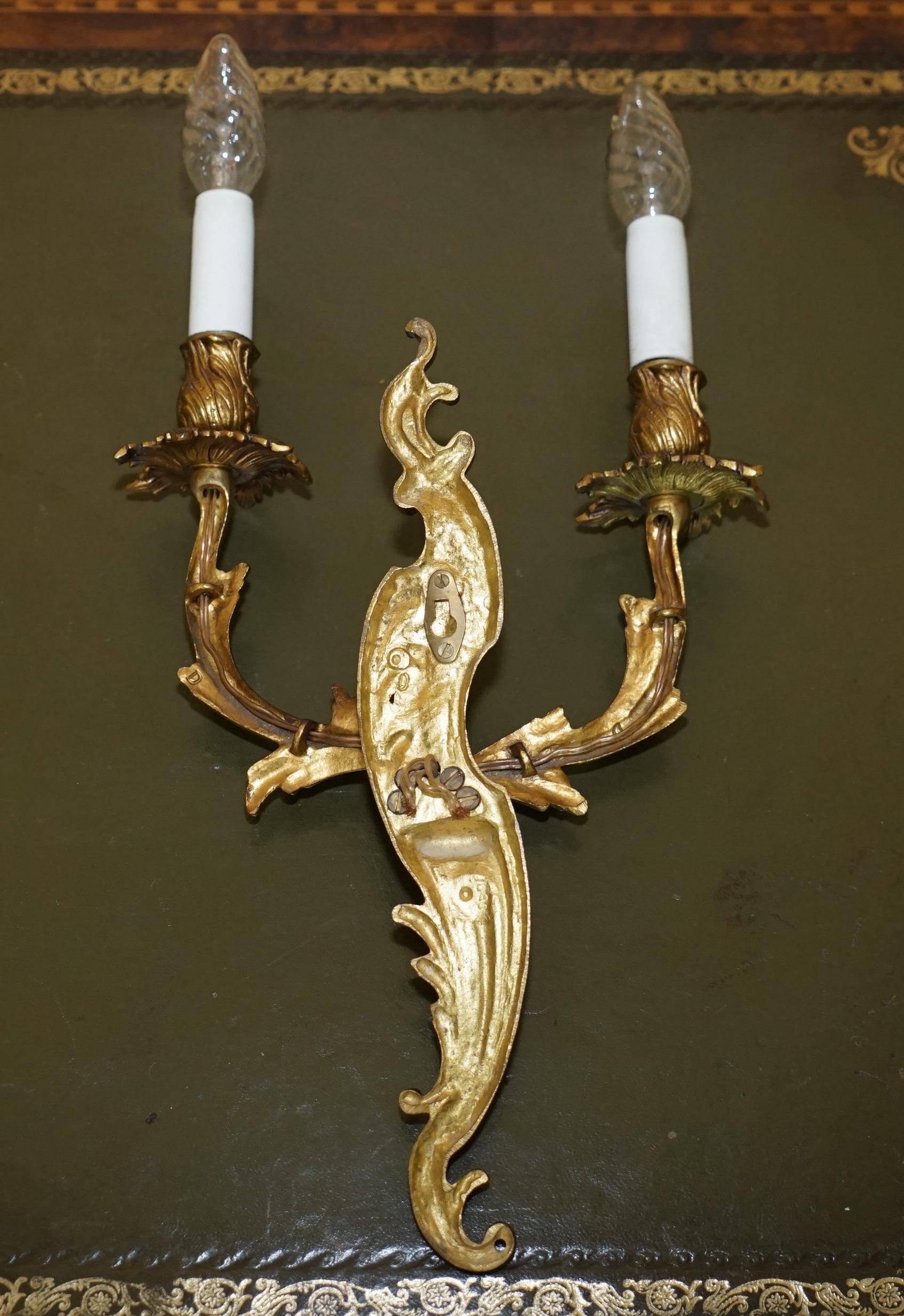 Pair of antique French wall sconces, gilded and bronzed, from the 1920s.