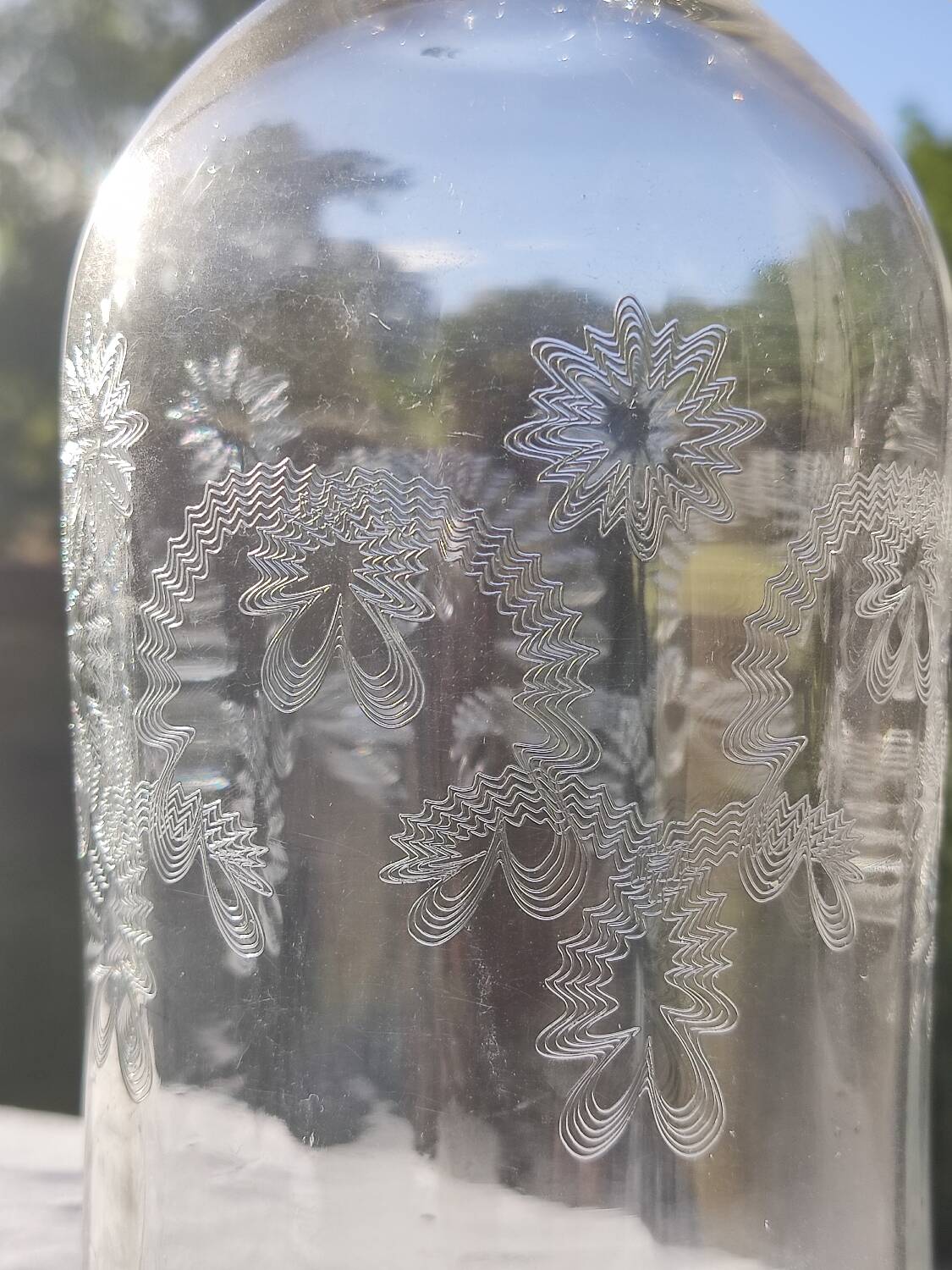 Two antique engraved glass bottles