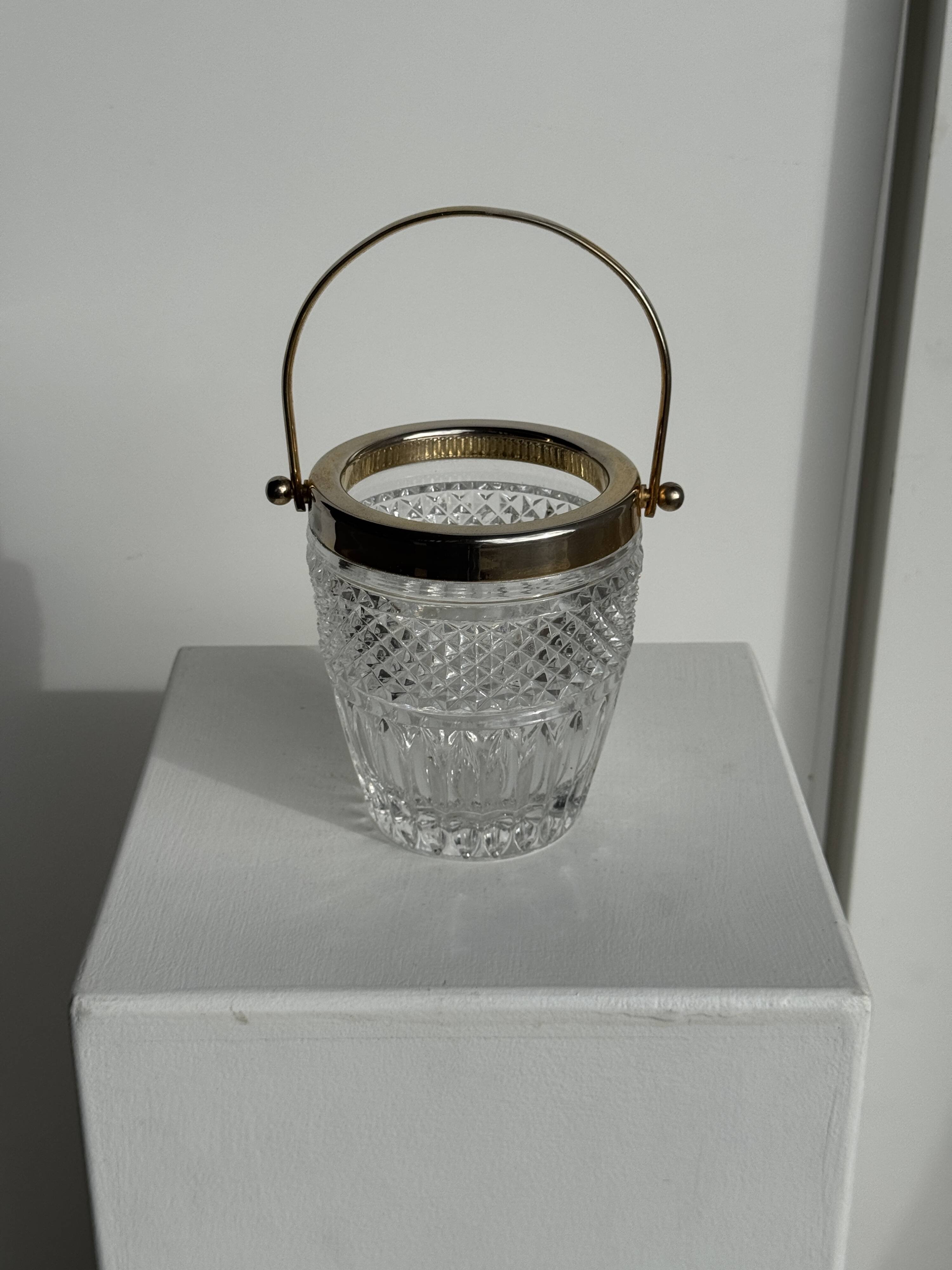 Small golden glass ice bucket with diamond point design and its scoop.