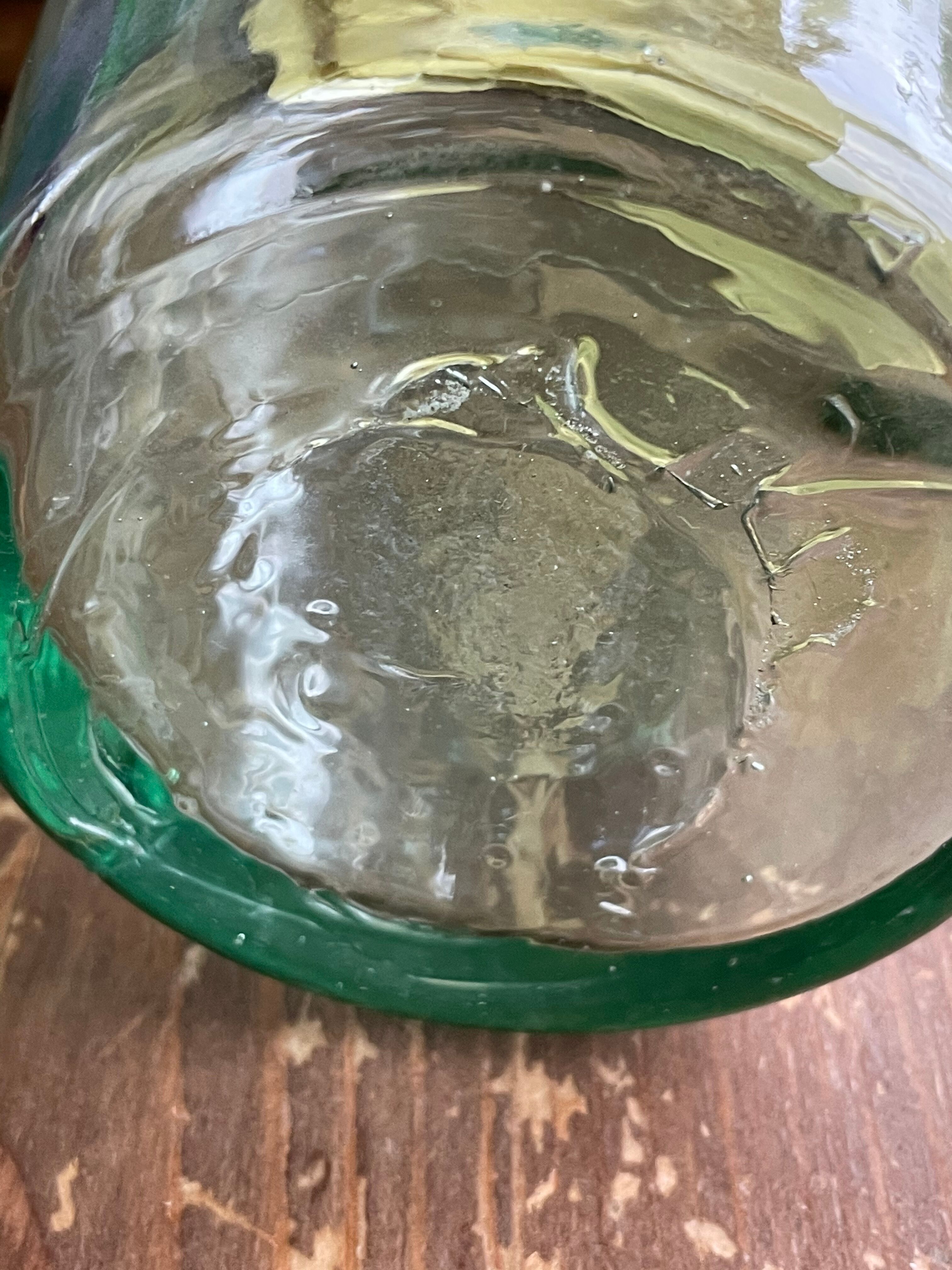 Green pitcher made of vintage glass