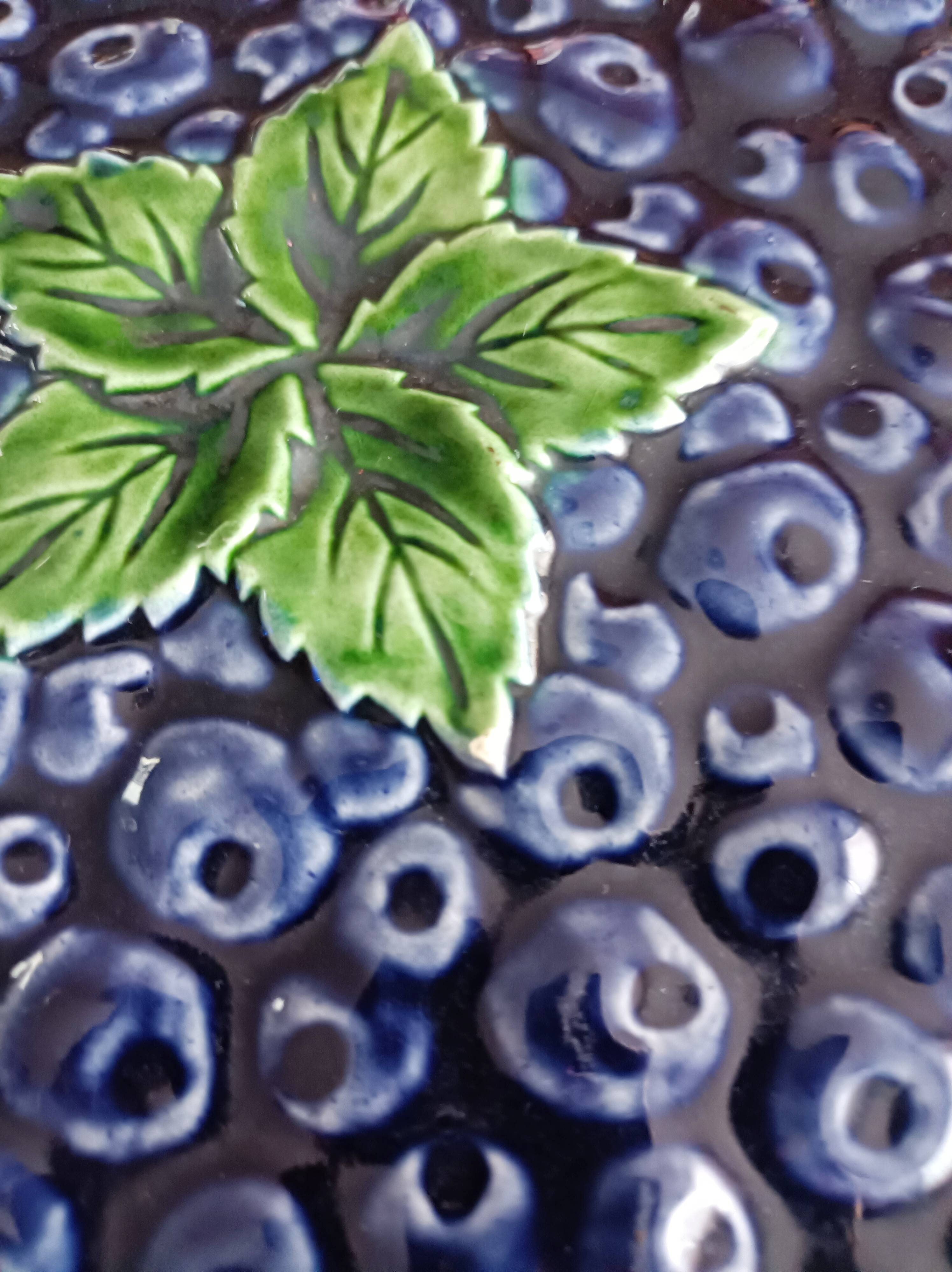 Pie dish on foot, in slip with blackberry decoration