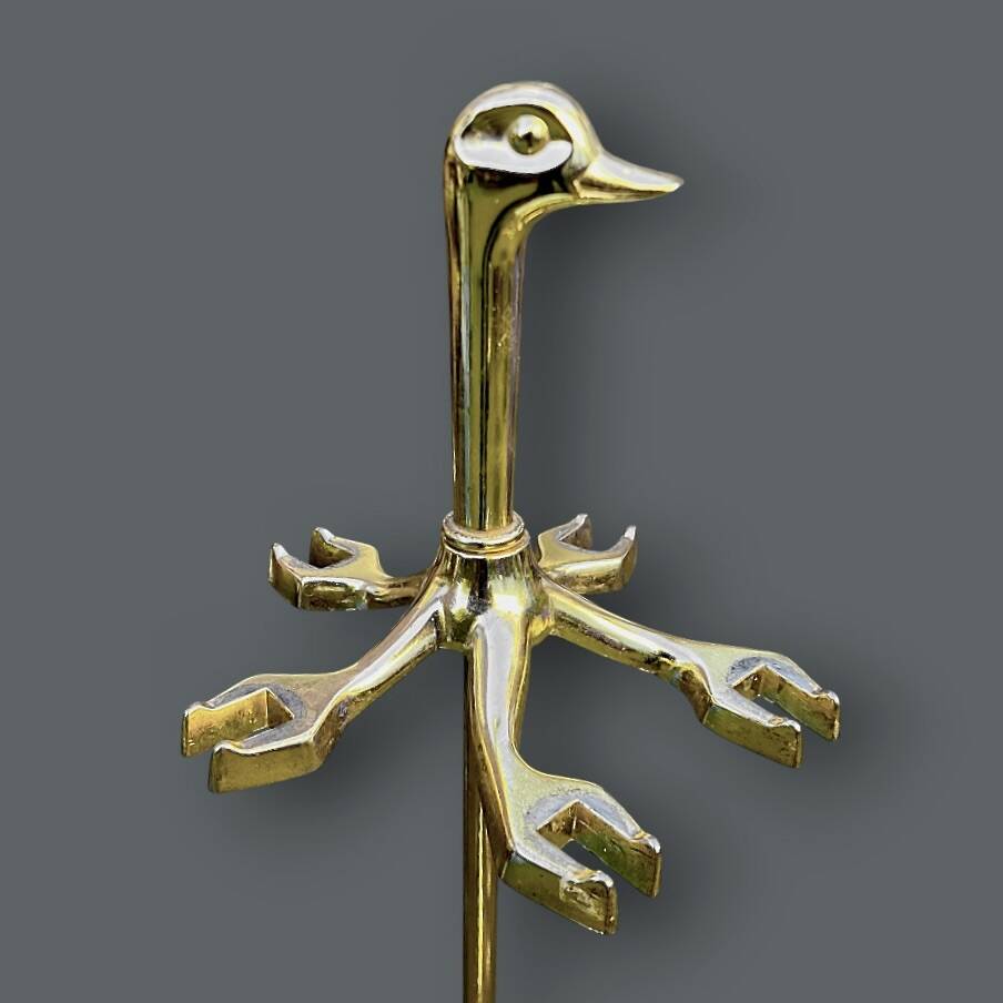 Antique fireplace tool in gilded zamak with duck head designs.