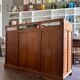 Counter, glass-fronted wooden workbench in dark wood, 8 drawers.