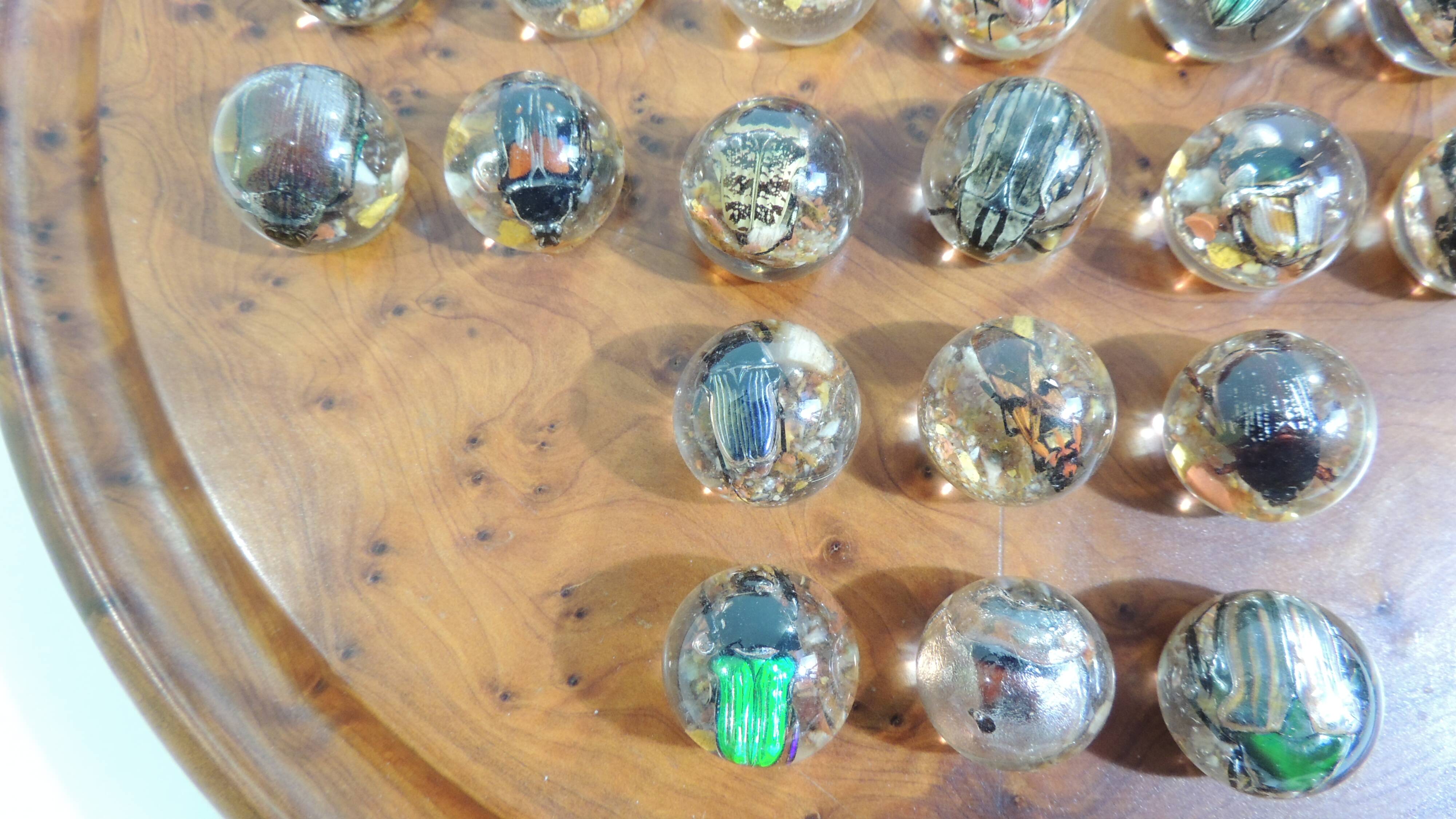 Vintage wooden solitaire game with resin balls and insects – Madaga