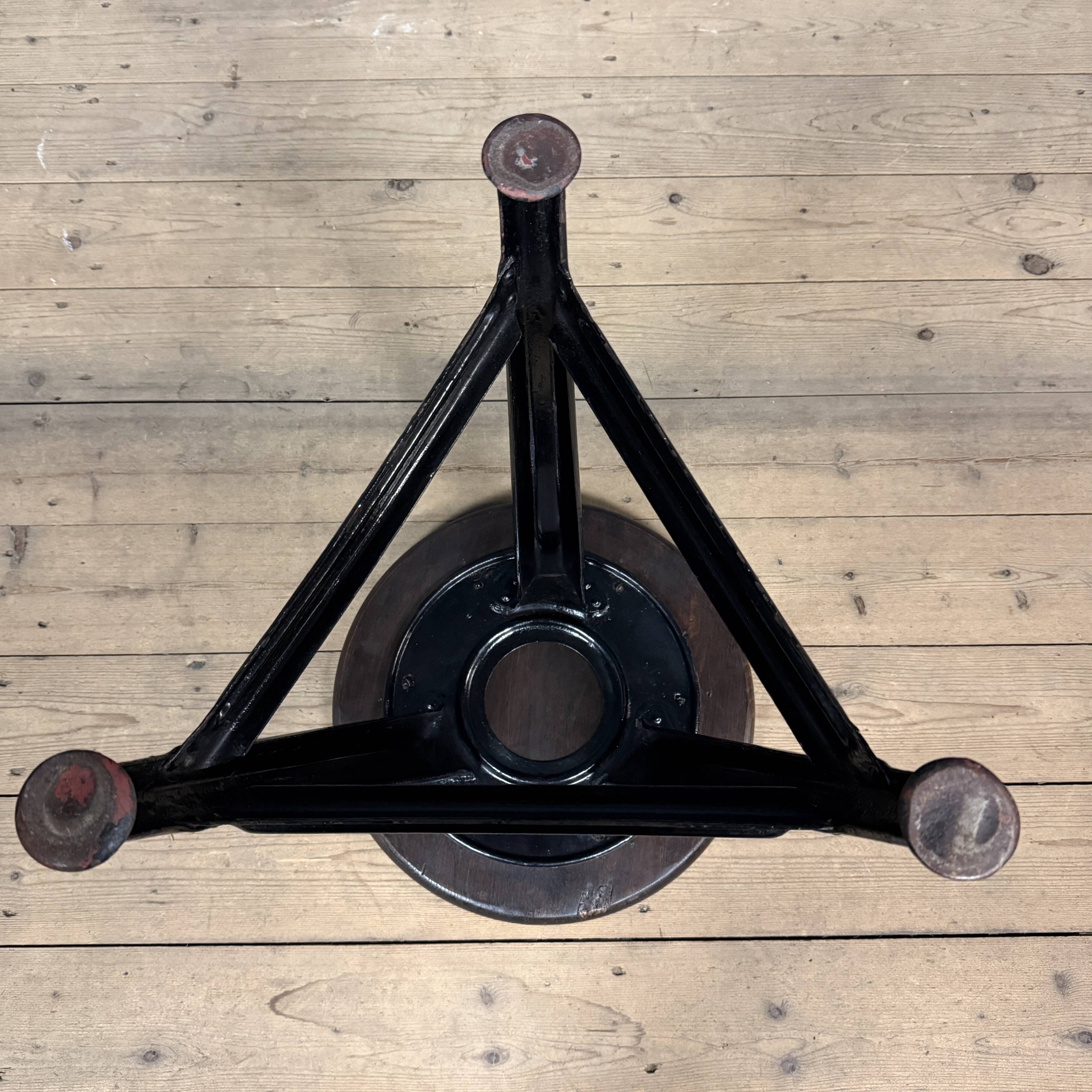 Unmarked black Rowac stool with a dark wood seat.