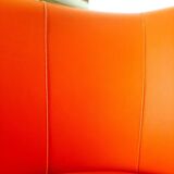 Curved vintage orange canapé with a pop spirit, seventies design piece.