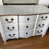 Patinated crossbow chest of drawers.