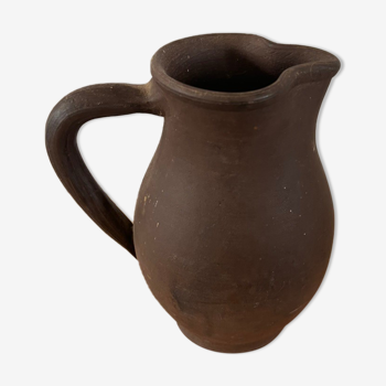 Ancient pitcher in earth