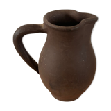 Ancient pitcher in earth