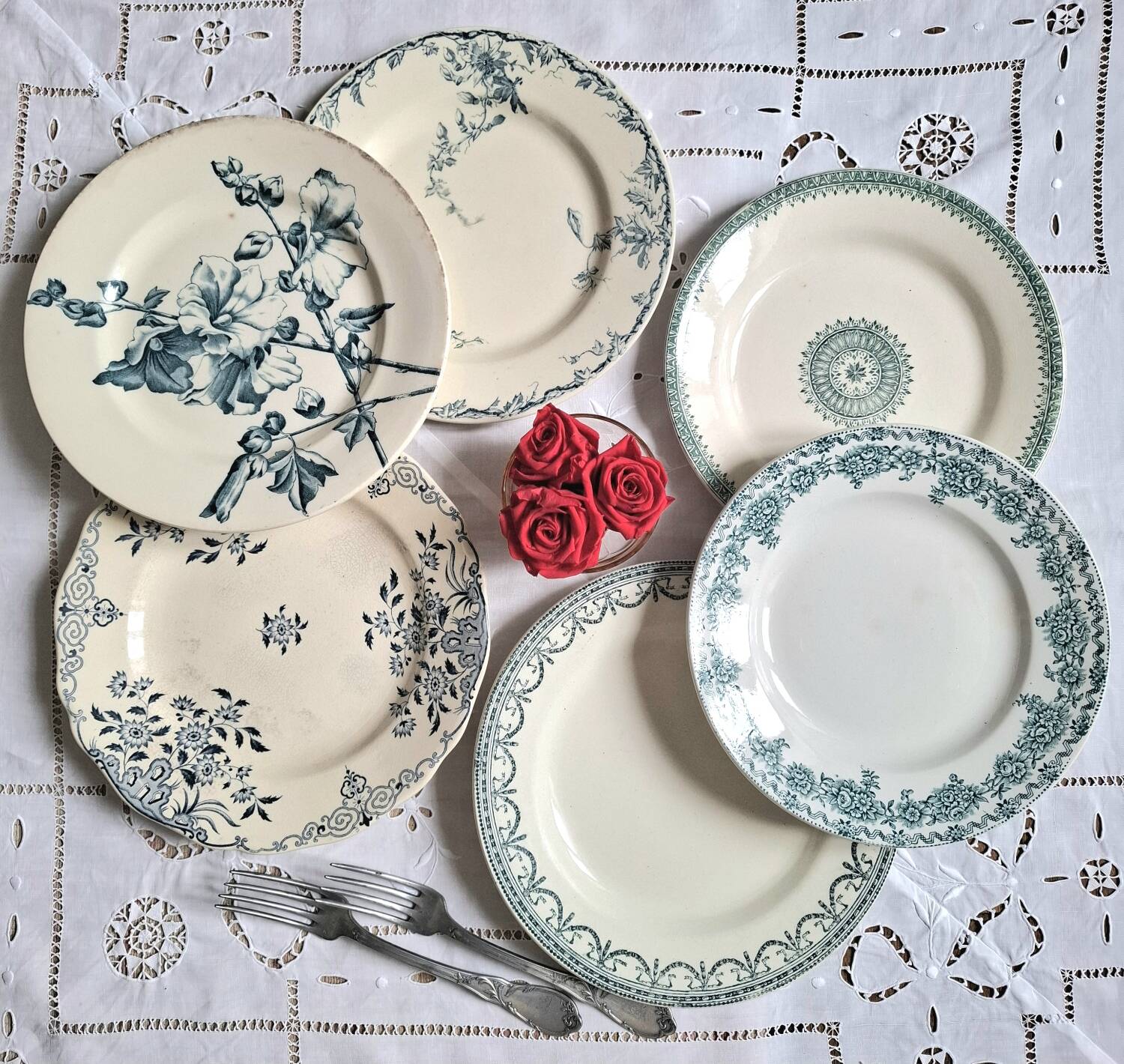 Old mismatched flat plates in iron earth earthenware accompanied by a dish