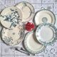 Old mismatched flat plates in iron earth earthenware accompanied by a dish