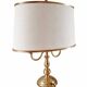 Empire style brass bouillotte lamp with an ivory oval shade.
