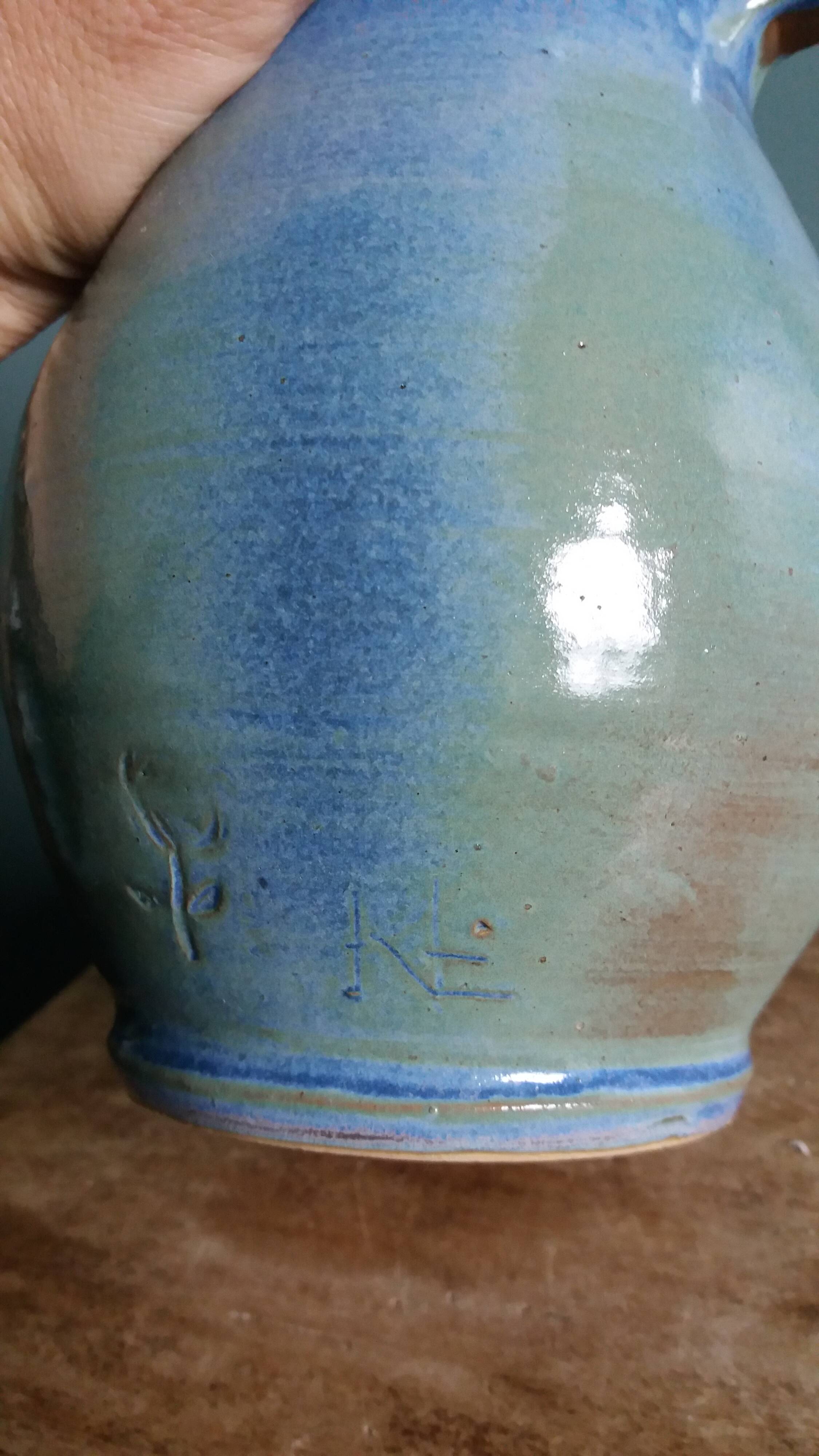 Enamel pitcher in pastel blue and green, signed