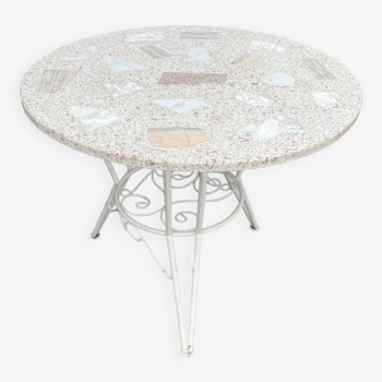 Round table of old garden wrought iron and terrazzo top