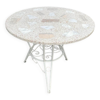 Round table of old garden wrought iron and terrazzo top
