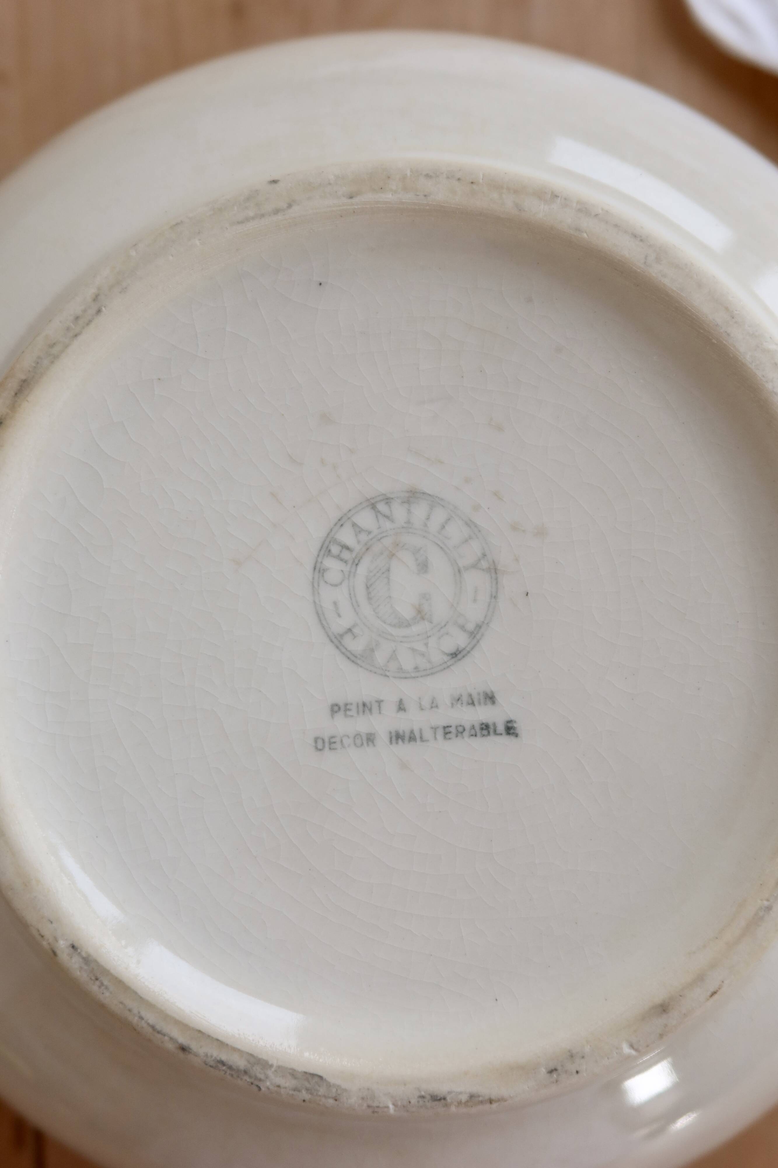 Vintage salad bowl in ivory faience from Chantilly with a rainbow trim.