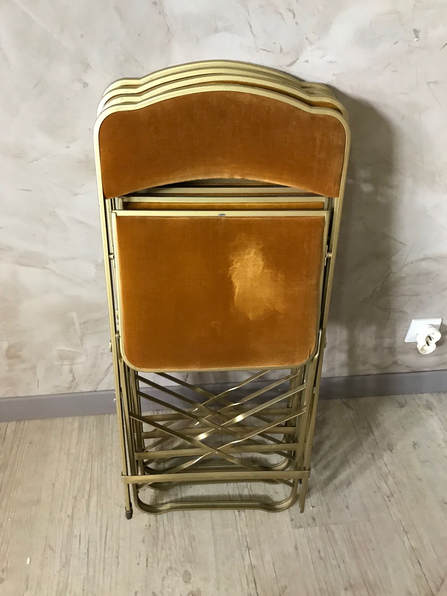Four folding velvet and brass chairs