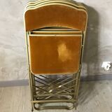 Four folding velvet and brass chairs