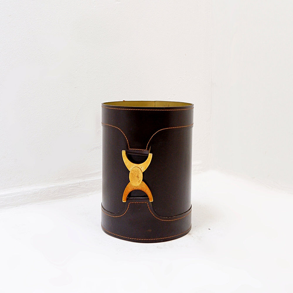 Brown leather wastepaper basket with decorative gold metal buckle.