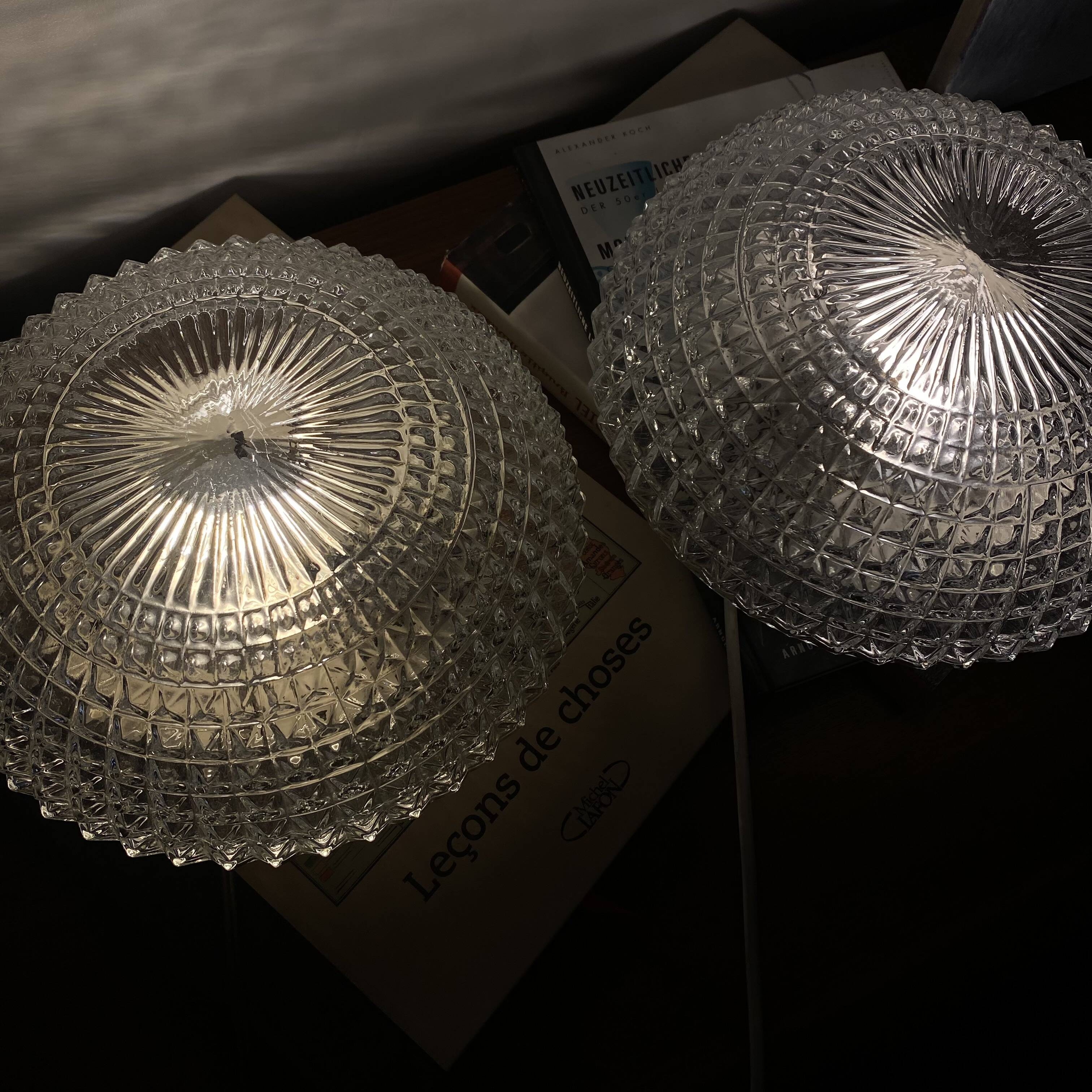 Large pair of round wall sconces ceiling lights in transparent glass.