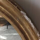 Antique oval gilded stucco mirror