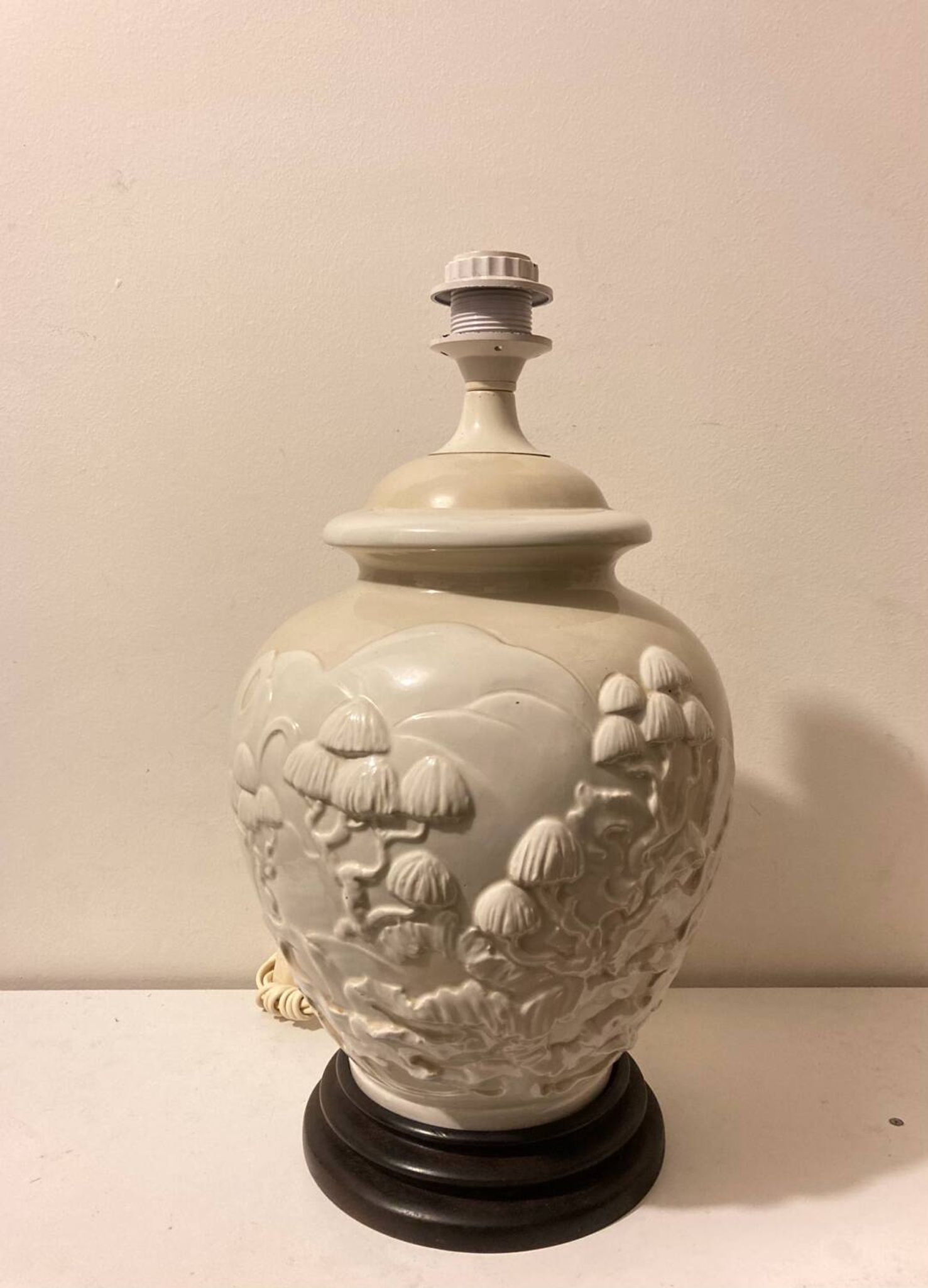 1980s ceramic table lamp with a wooden base and adjustable shade.