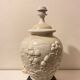 1980s ceramic table lamp with a wooden base and adjustable shade.