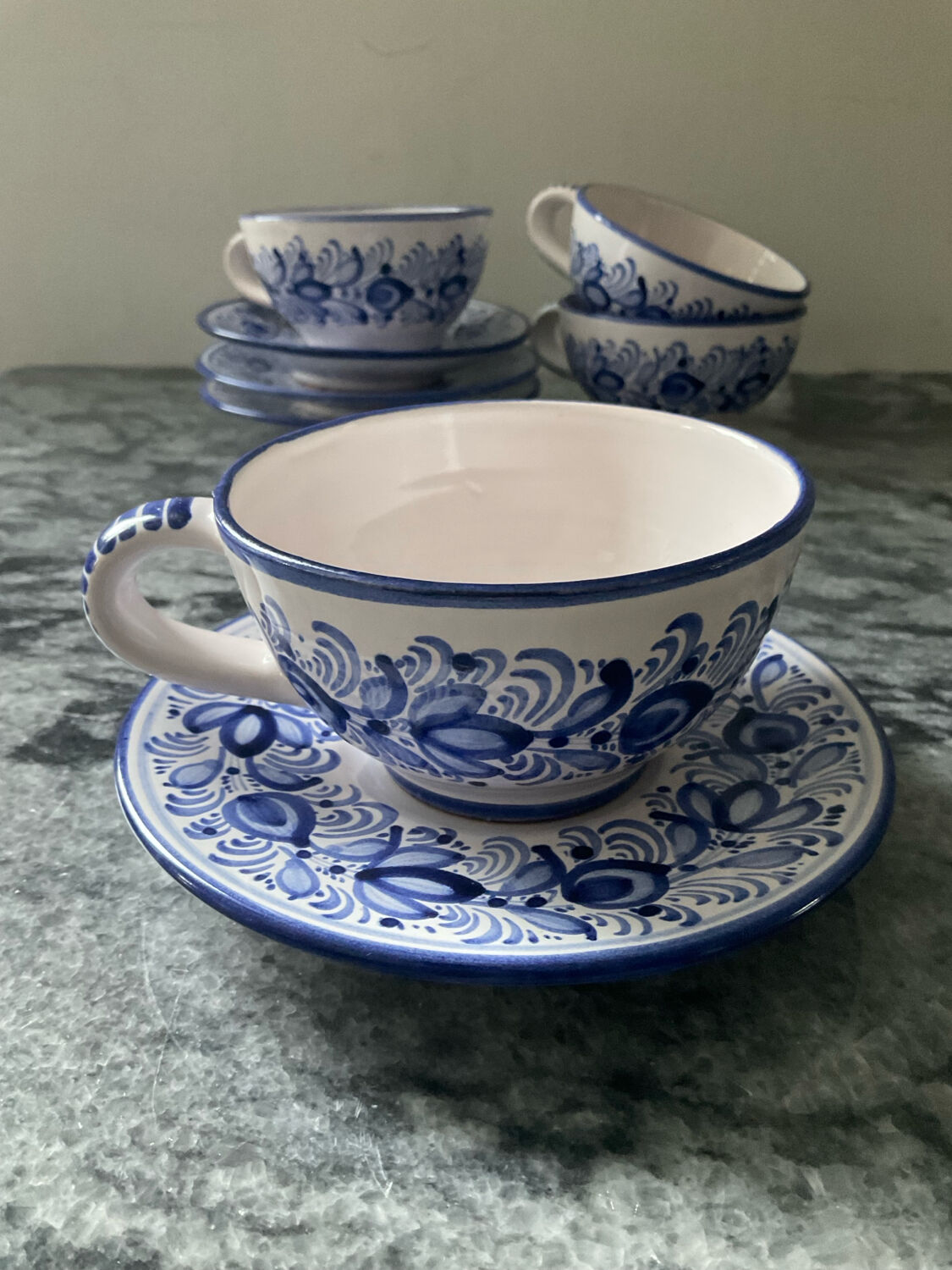 Set of 4 white/blue ceramic cups and saucers.