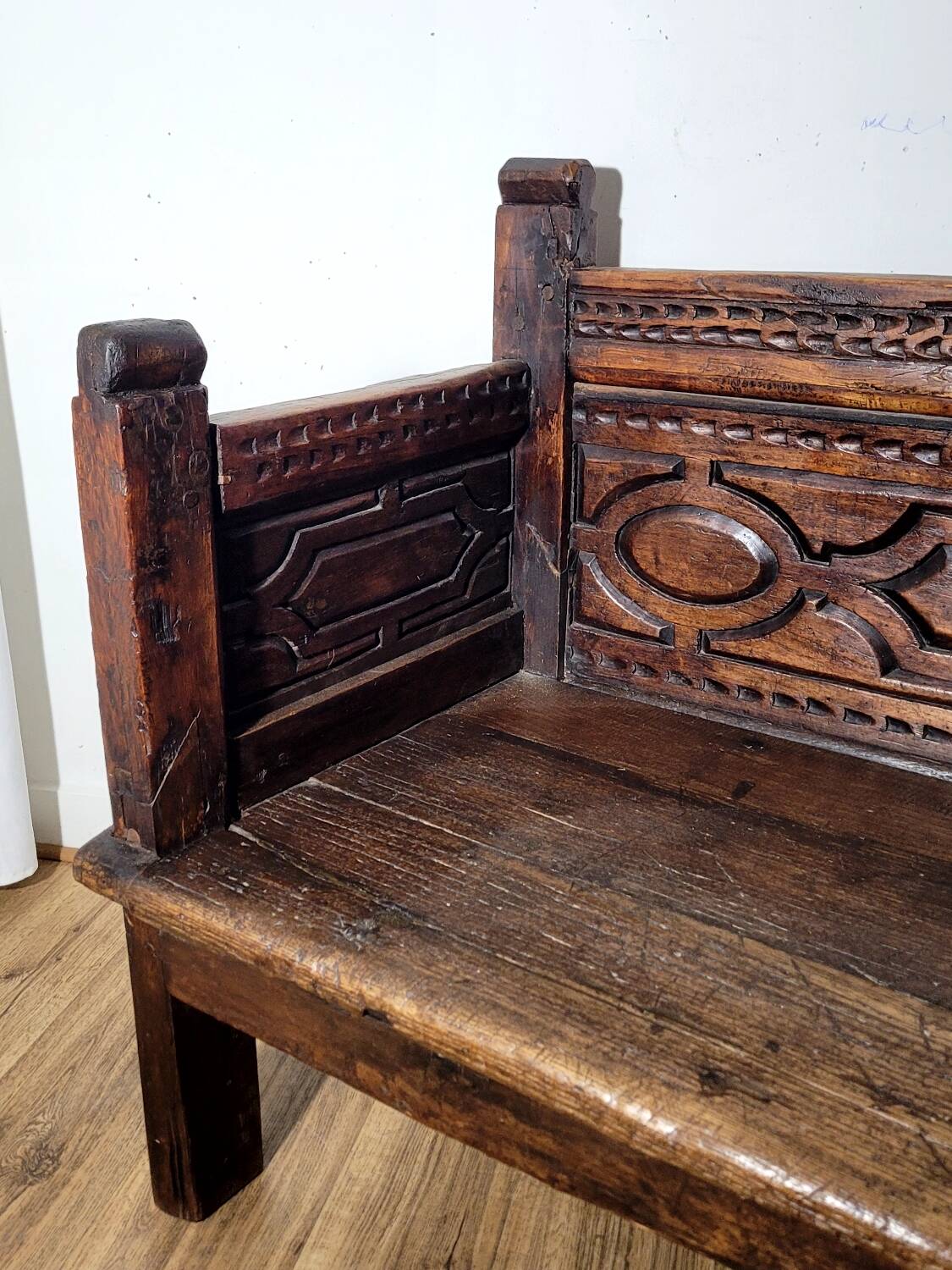 Antique carved solid wood bench from the early 20th century