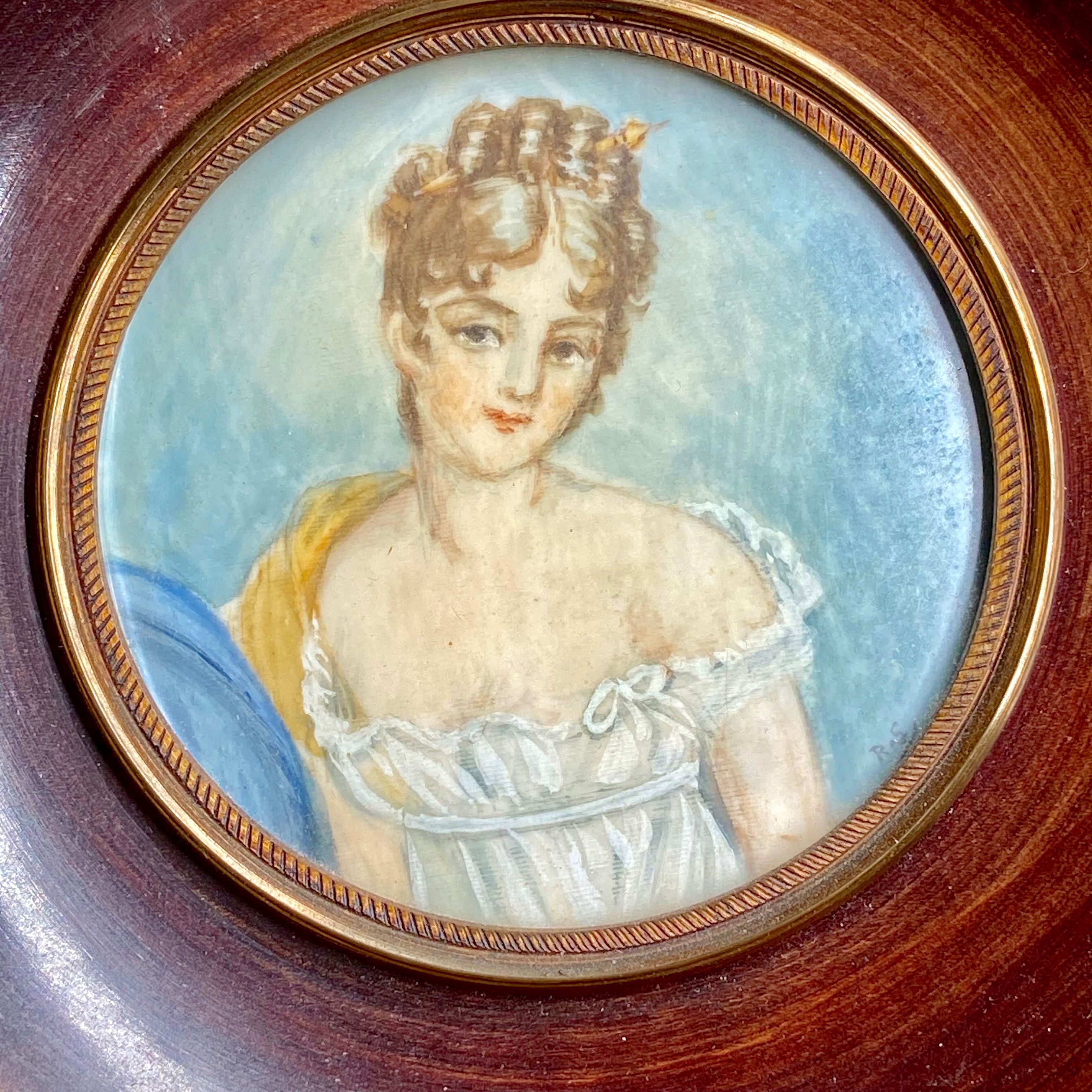 Miniature female portrait in wooden and brass frame