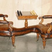High Victorian leather tête-à-tête canapé with a walnut burr chessboard.