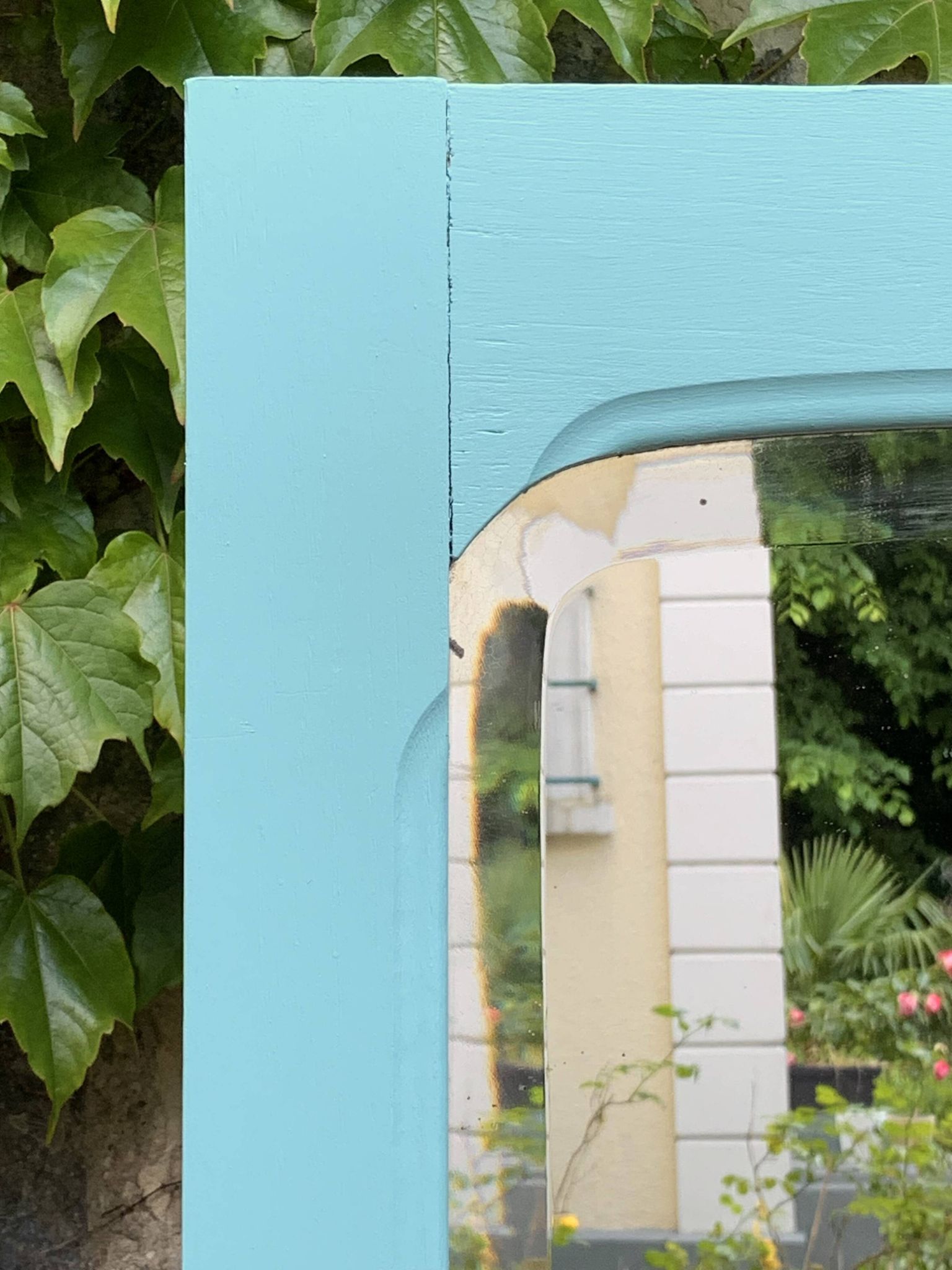 Beveled mirror on turquoise Parisian door
