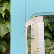 Beveled mirror on turquoise Parisian door