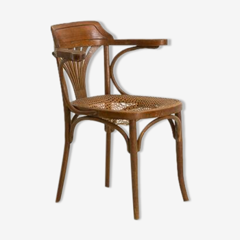 Bistro chair with curved wooden armrests and canning seat