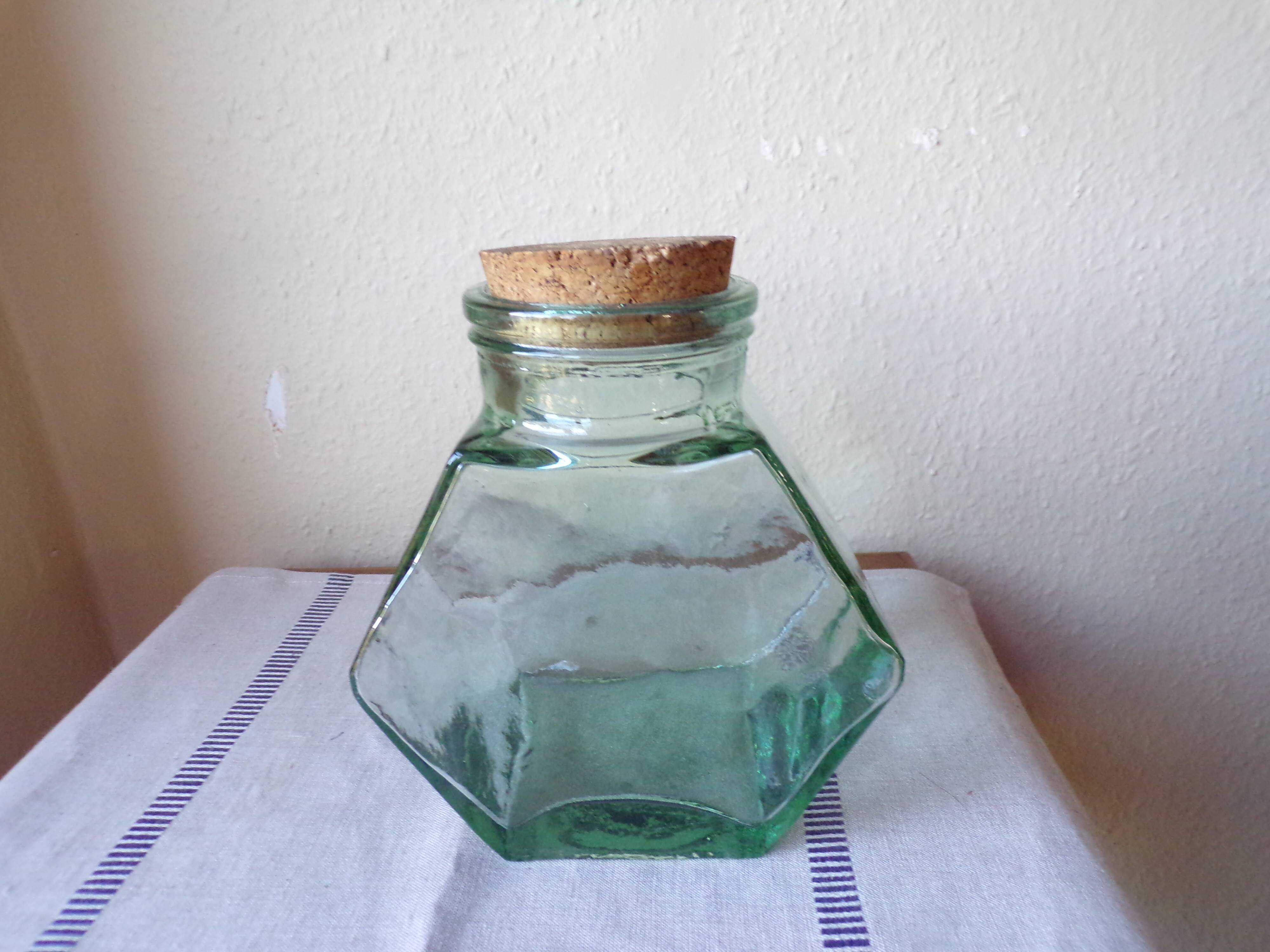 Old thick glass of a light green jar