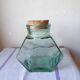 Old thick glass of a light green jar
