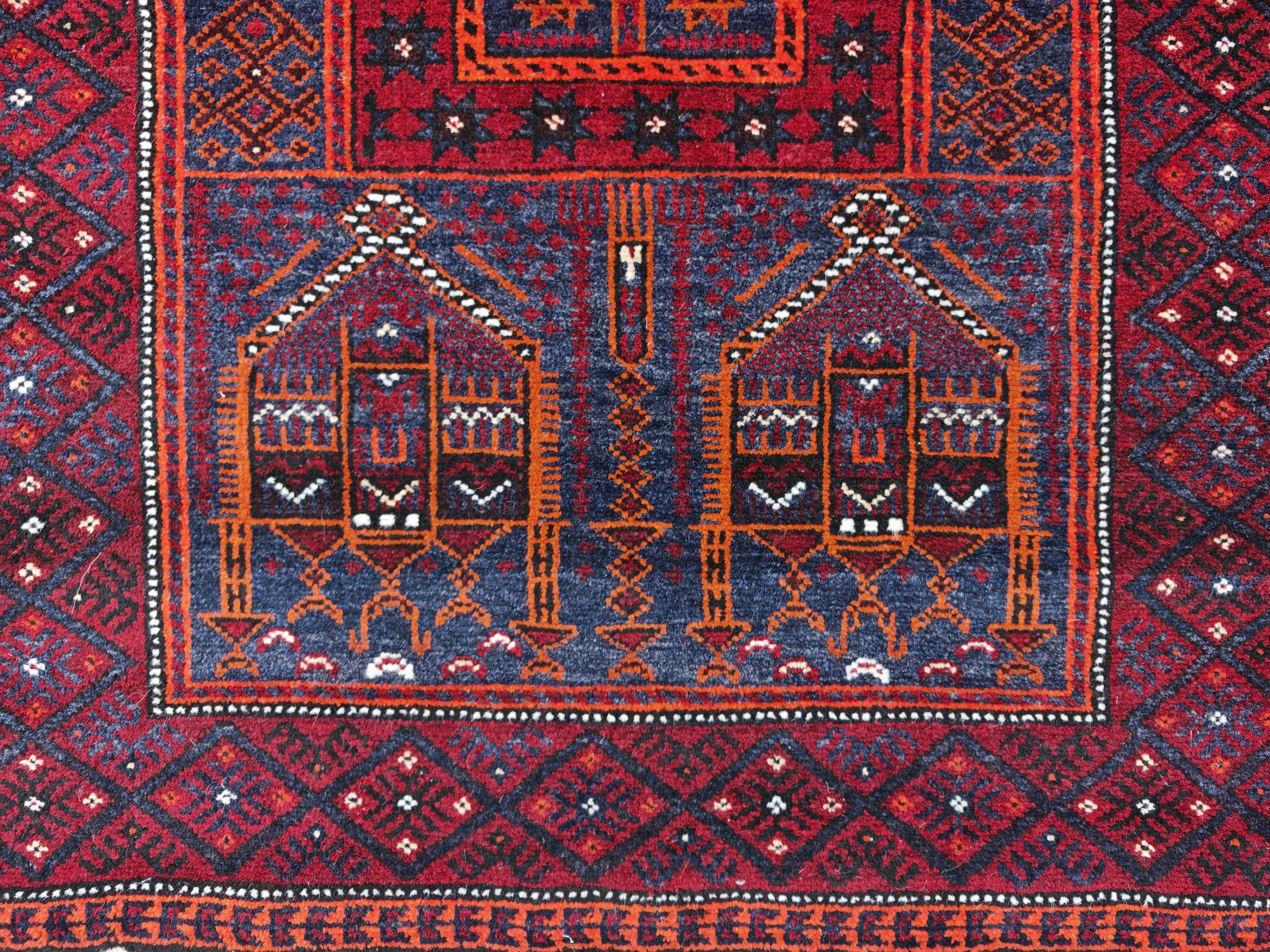 Vintage hand-knotted Persian Baluch prayer rug from the 1940s.