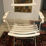 White armchair with wooden slats and metal structure
