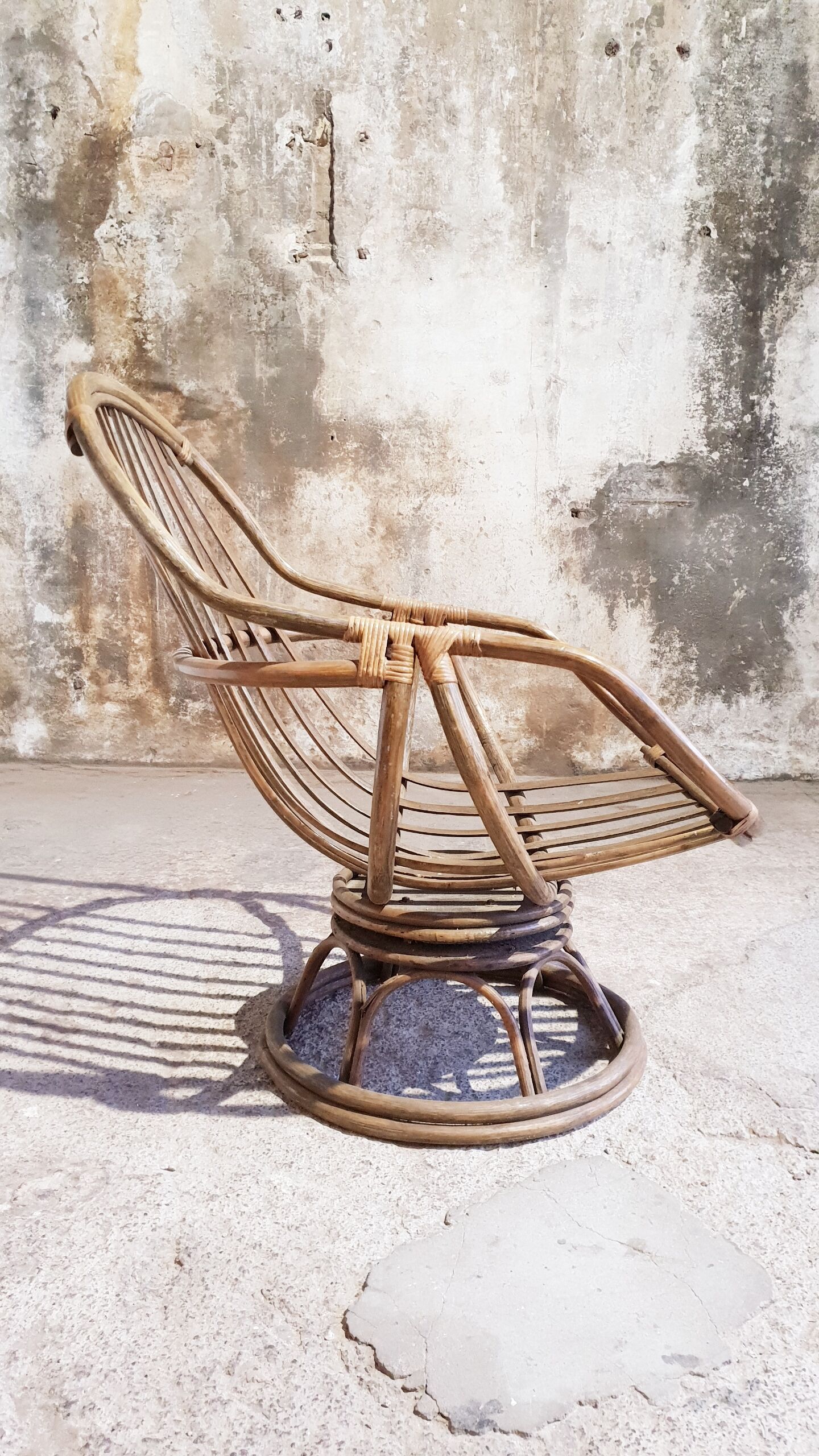 Antique swivel rattan armchair
