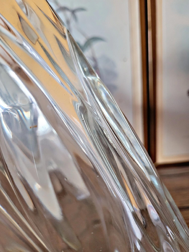 Vintage thick glass vase with twisted ribbed relief.