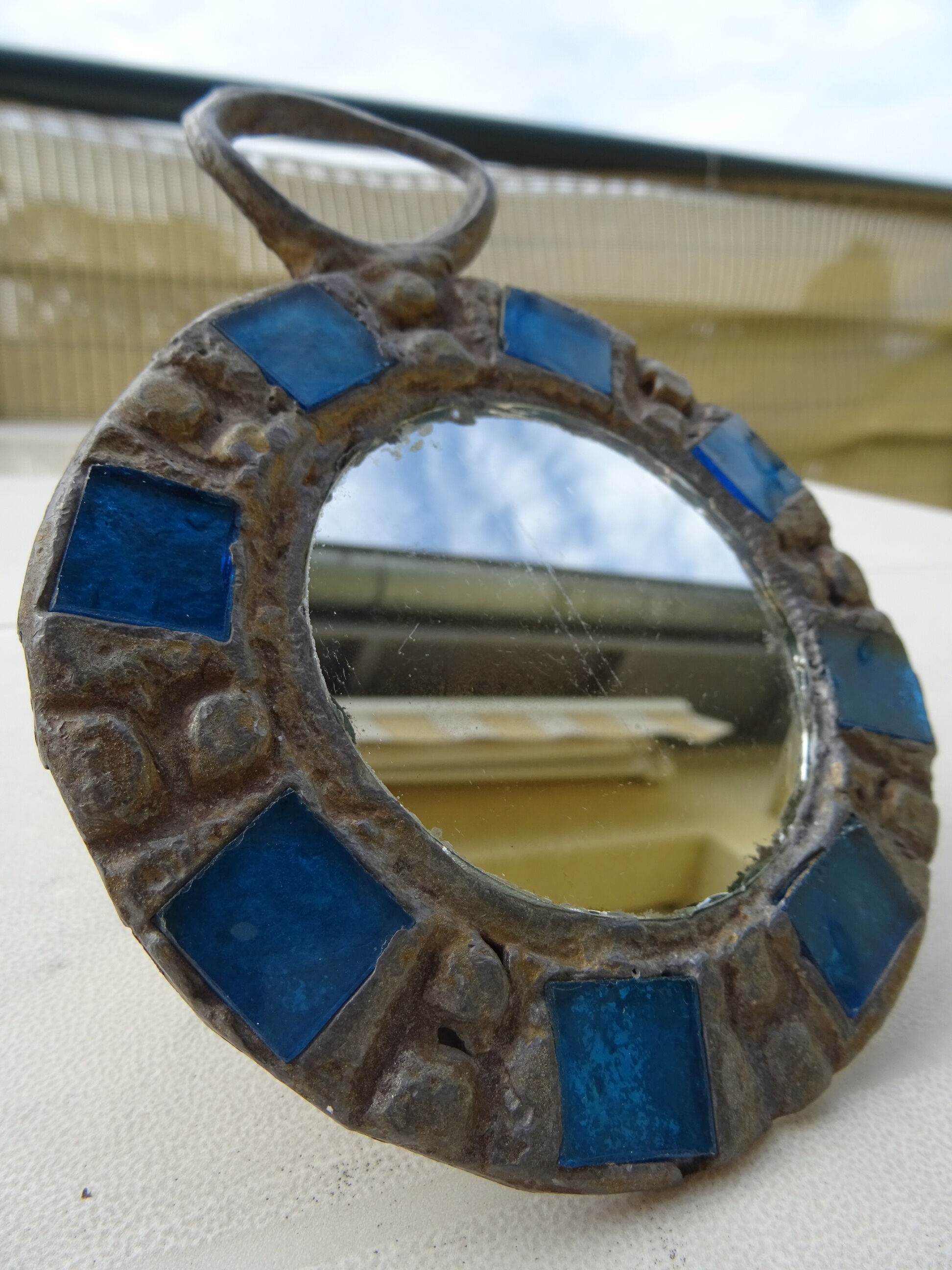 Mirror in metal and blue glass