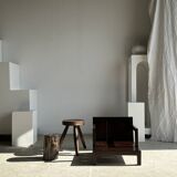 Small low armchair in varnished brown wood