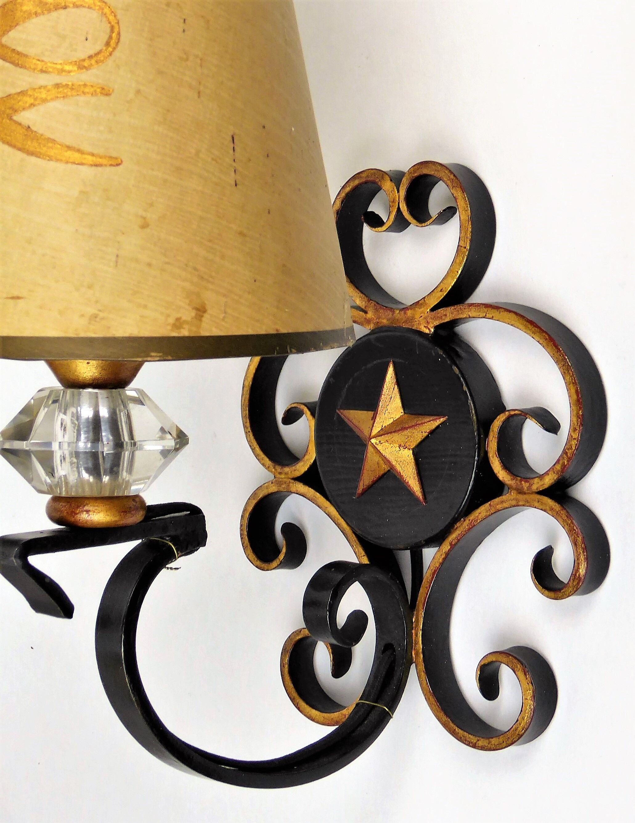 1950 gold star and black metal sconces