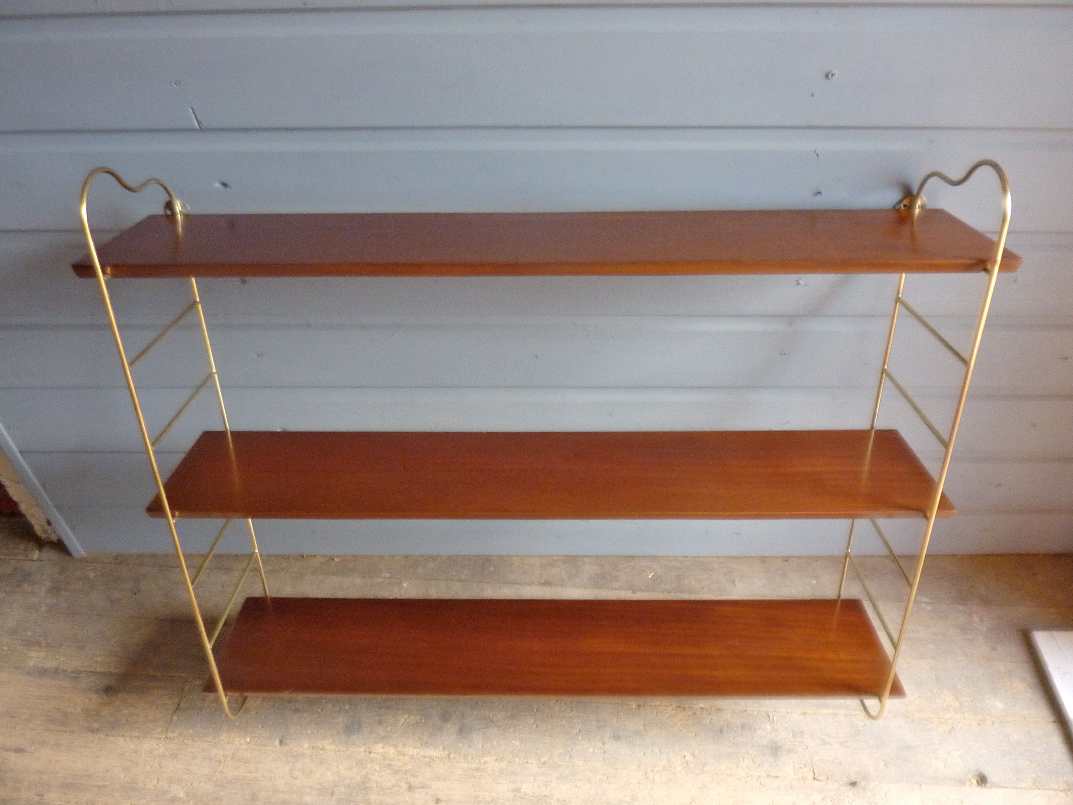 Wall shelves in brass and teak of the 1960s