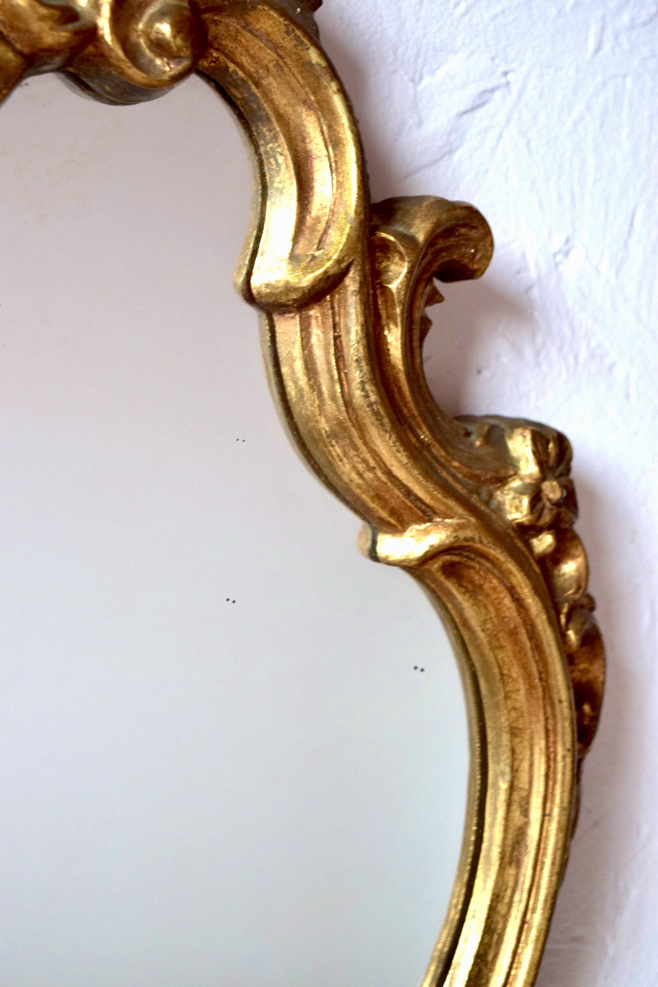 Large rococo mirror in gold painted wood