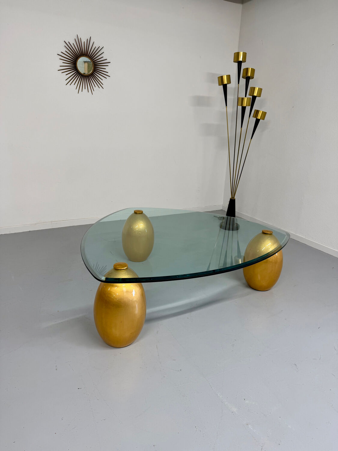 Vintage Italian design coffee table with a glass top and gold base, dating from the 1980s.