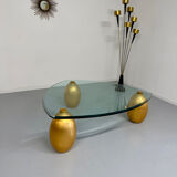 Vintage Italian design coffee table with a glass top and gold base, dating from the 1980s.