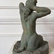 Sculpture of a naked woman titled "Youth" in terracotta.